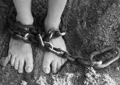 Chains wrapped around a pair of feet, depictng slavery