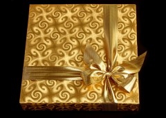 A present in a golden gift box with a golden bow