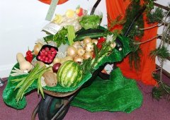 A wheelbarrow full of harvest vegetables