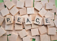 TThe word Peace spelled out using Scrabble tiles