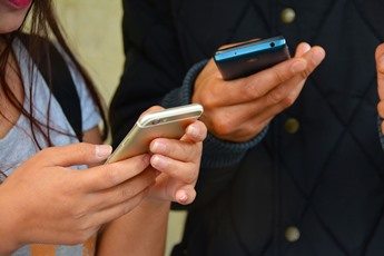 People texting on smartphones